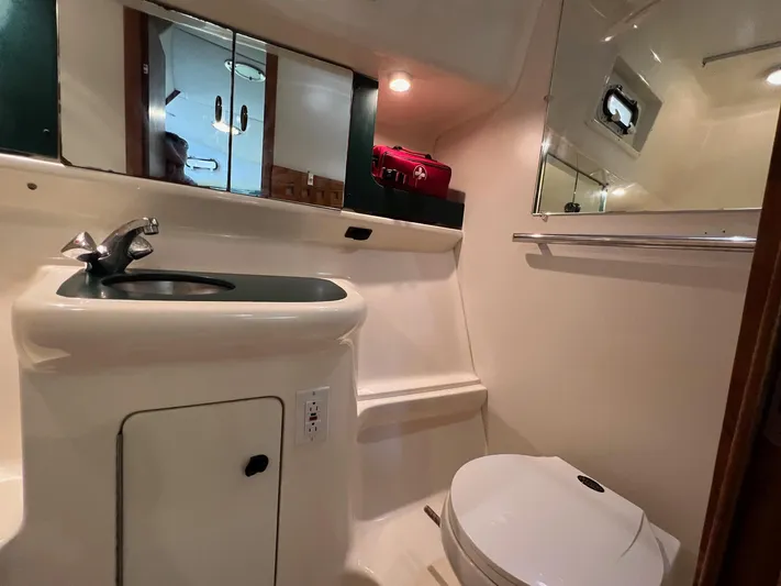  Yacht Photos Pics Bathroom interior of 1998 Pursuit 3400 Offshore DIESEL boat, featuring sink and toilet.