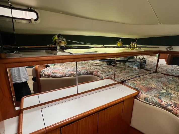  Yacht Photos Pics Interior of 1998 Pursuit 3400 Offshore DIESEL boat with fishing rods and mirrored cabinets.