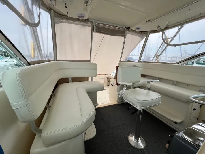  Yacht Photos Pics 1998 Pursuit 3400 Offshore DIESEL boat interior with white seating and helm chair.