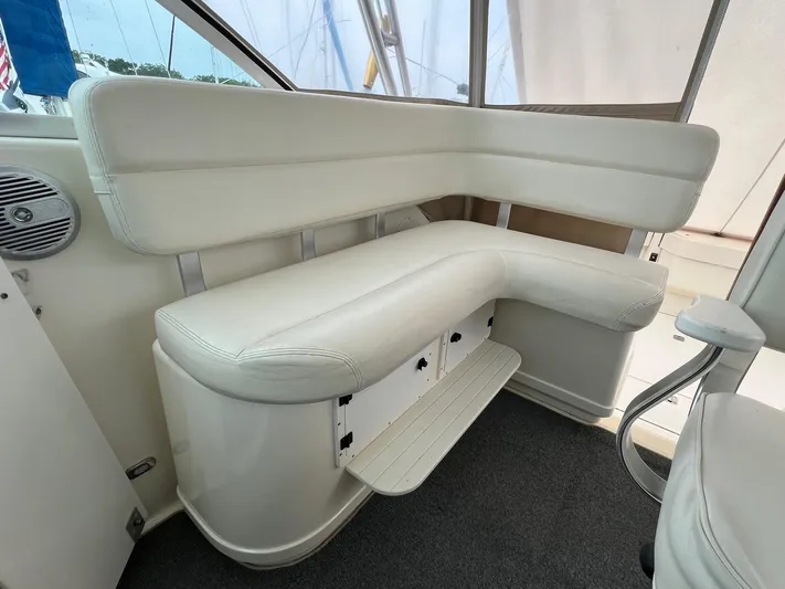  Yacht Photos Pics 1998 Pursuit 3400 Offshore DIESEL boat interior with white cushioned seating.