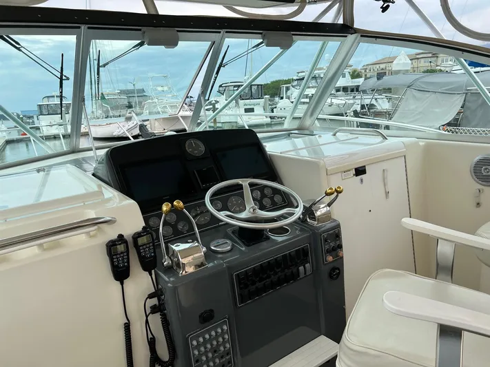  Yacht Photos Pics 1998 Pursuit 3400 Offshore DIESEL boat cockpit with steering wheel and control panel.