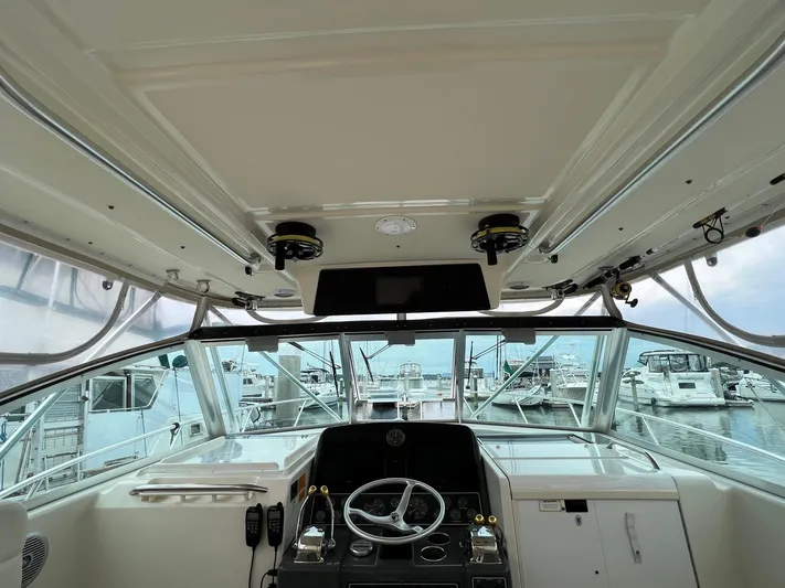  Yacht Photos Pics 1998 Pursuit 3400 Offshore DIESEL boat helm with steering wheel and controls, docked at marina.