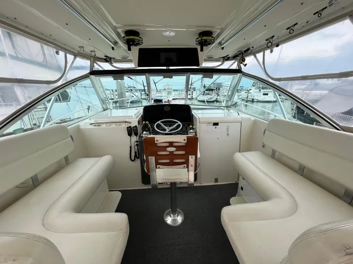  Yacht Photos Pics 1998 Pursuit 3400 Offshore DIESEL boat interior with helm, seating, and panoramic windows.