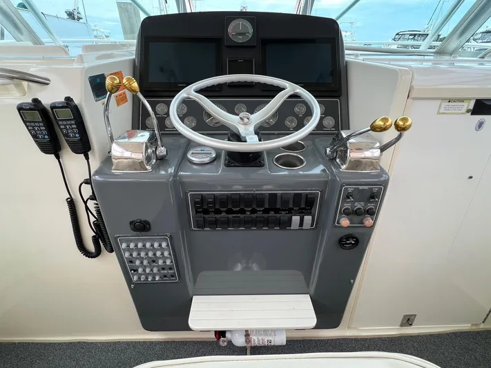  Yacht Photos Pics 1998 Pursuit 3400 Offshore DIESEL boat helm with steering wheel and control panel.