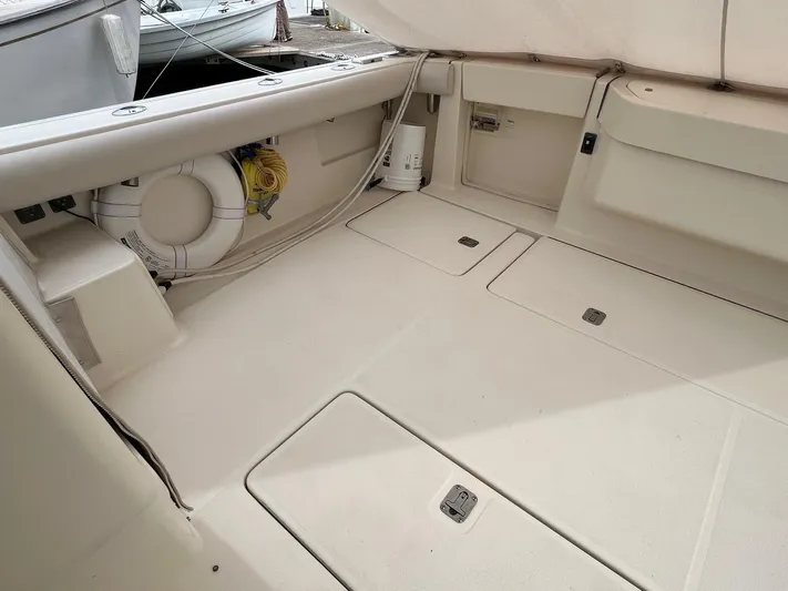  Yacht Photos Pics 1998 Pursuit 3400 Offshore DIESEL boat deck with storage compartments and safety equipment.