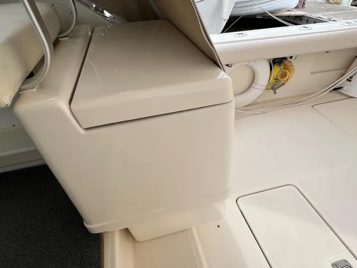  Yacht Photos Pics 1998 Pursuit 3400 Offshore Diesel boat interior with storage compartment and seating area.