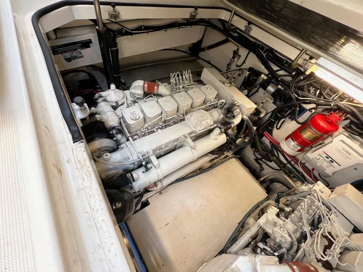  Yacht Photos Pics Engine compartment of a 1998 Pursuit 3400 Offshore DIESEL boat, featuring a well-maintained engine.