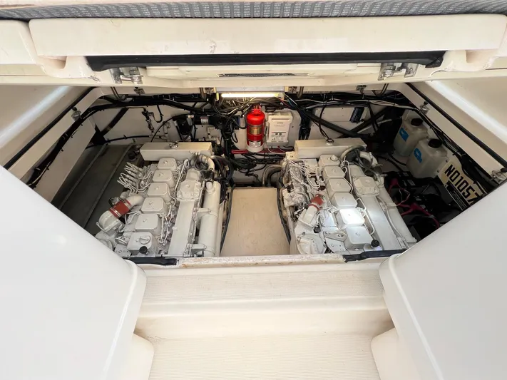  Yacht Photos Pics Engine compartment of a 1998 Pursuit 3400 Offshore DIESEL boat, showcasing dual engines.
