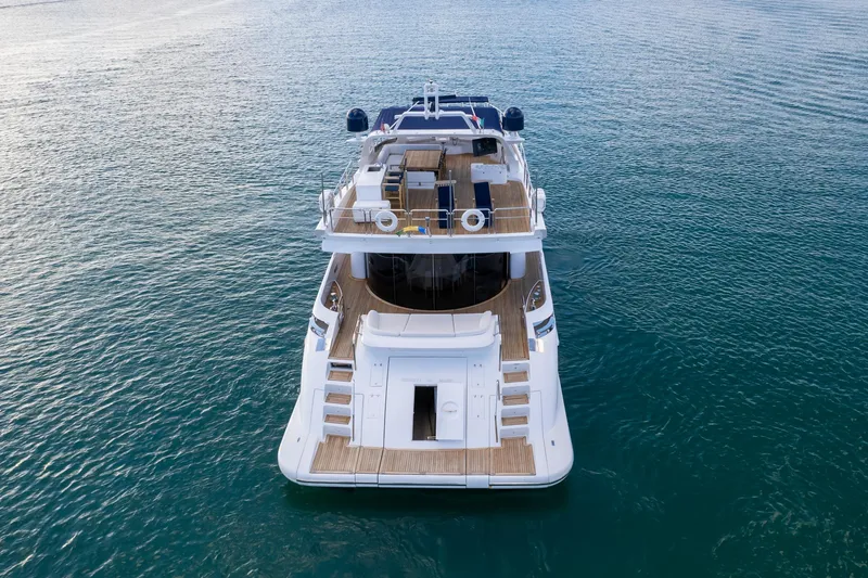  Yacht Photos Pics Azimut 98 Leonardo 2006 yacht on calm blue water, rear view.