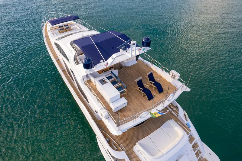  Yacht Photos Pics Luxurious 2006 Azimut 98 Leonardo yacht on serene water, featuring spacious deck and seating.