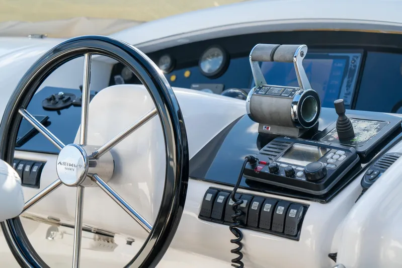  Yacht Photos Pics Control panel of a 2006 Azimut 98 Leonardo yacht, featuring steering wheel and navigation instruments.