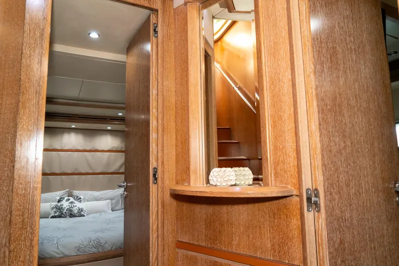  Yacht Photos Pics Luxurious interior of 2006 Azimut 98 Leonardo yacht with wooden finishes and cozy bedroom.