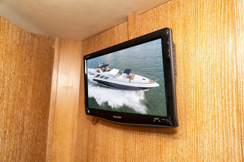  Yacht Photos Pics Wall-mounted TV displaying Azimut 98 Leonardo yacht cruising on water, 2006 model.