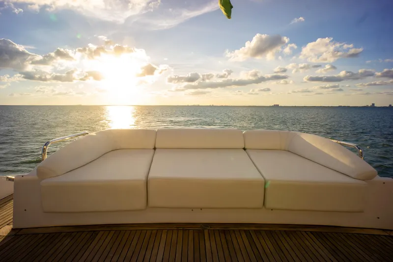  Yacht Photos Pics Luxurious Azimut 98 Leonardo yacht deck with white sofa, ocean view, and sunset sky, 2006 model.