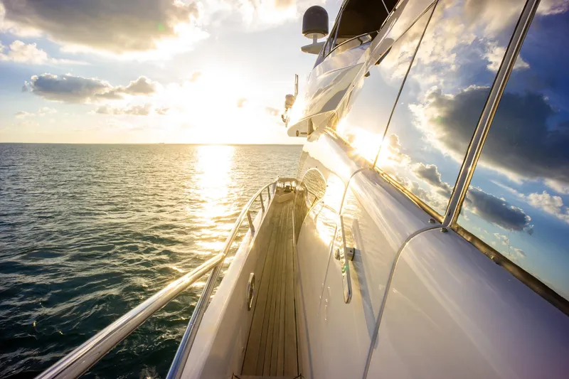  Yacht Photos Pics Azimut 98 Leonardo yacht cruising at sunset, reflecting sunlight on calm ocean waters.