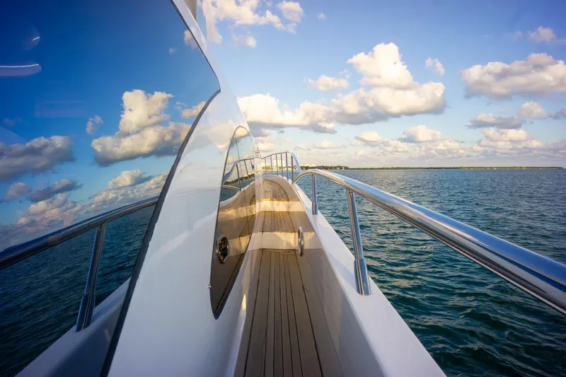  Yacht Photos Pics Azimut 98 Leonardo yacht deck with ocean view, 2006 model, reflecting blue sky and clouds.