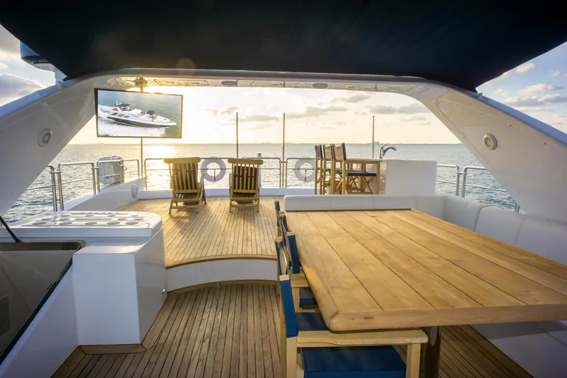  Yacht Photos Pics Luxurious 2006 Azimut 98 Leonardo yacht deck with wooden furniture and ocean view.