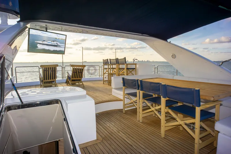  Yacht Photos Pics Luxurious 2006 Azimut 98 Leonardo yacht deck with seating, ocean view, and TV.