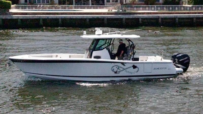 Sammy G Yacht Photos Pics 2020 Blackfin 332 CC boat cruising on water near waterfront homes.