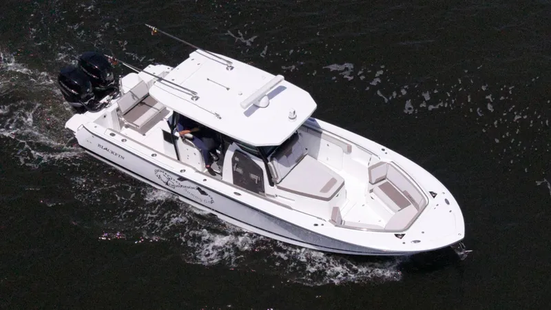 Sammy G Yacht Photos Pics 2020 Blackfin 332 CC boat cruising on water, aerial view.