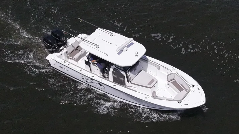 Sammy G Yacht Photos Pics 2020 Blackfin 332 CC boat cruising on water, aerial view.