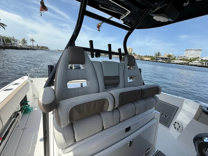 Sammy G Yacht Photos Pics 2020 Blackfin 332 CC boat interior with plush seating, overlooking a scenic waterfront.