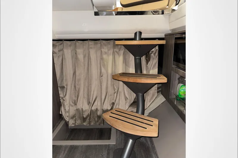  Yacht Photos Pics Interior of 2021 Sea Ray SLX 400 with modern wooden steps and curtain backdrop.