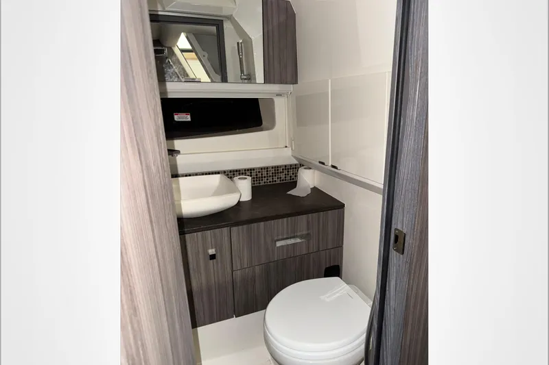  Yacht Photos Pics 2021 Sea Ray SLX 400 bathroom interior with modern fixtures and wood cabinetry.