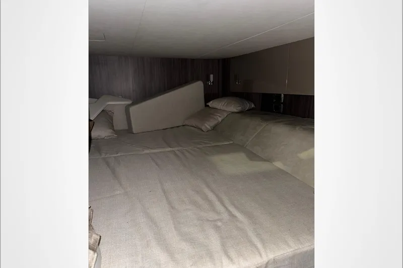  Yacht Photos Pics Interior cabin of 2021 Sea Ray SLX 400 with beige bedding and cushions.