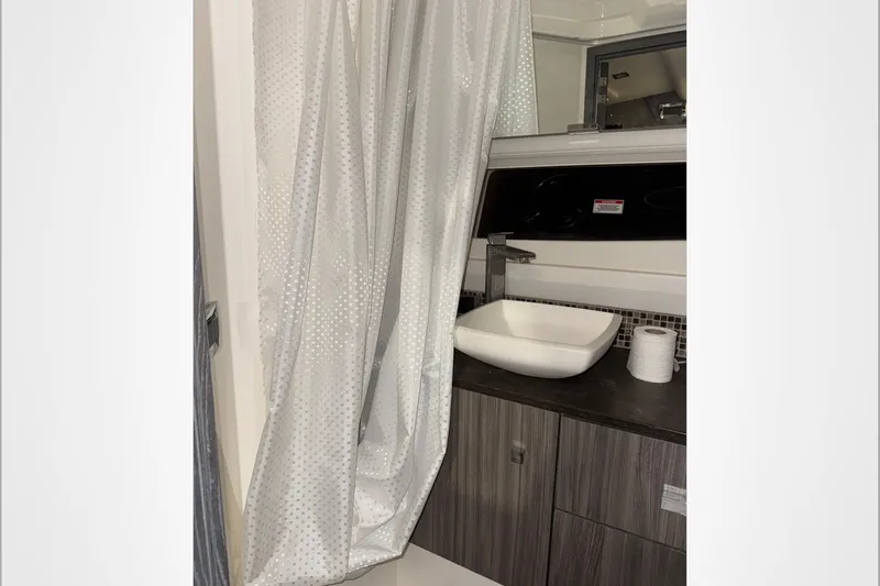  Yacht Photos Pics 2021 Sea Ray SLX 400 bathroom with modern sink and shower curtain.