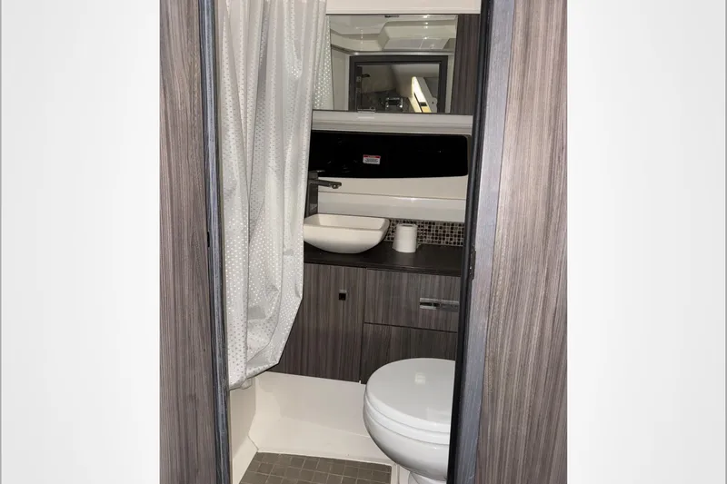  Yacht Photos Pics 2021 Sea Ray SLX 400 bathroom with modern fixtures and wood accents.