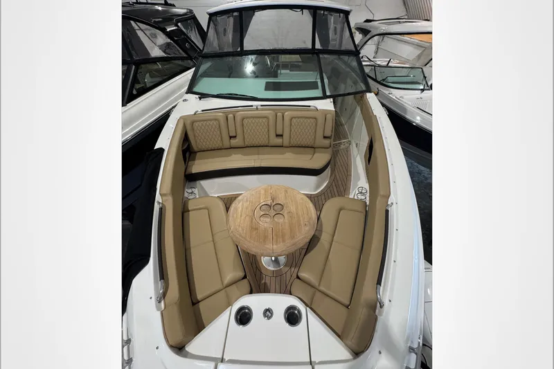  Yacht Photos Pics 2021 Sea Ray SLX 400 boat interior with tan seating and wooden table.