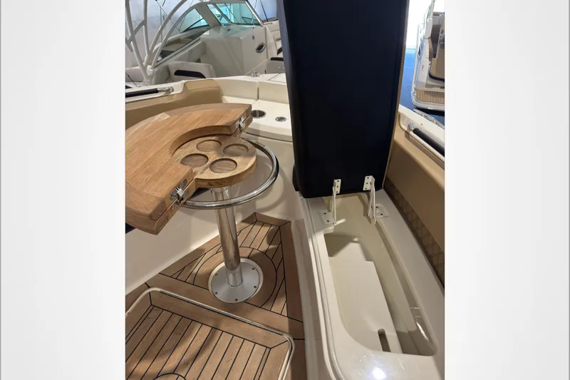  Yacht Photos Pics 2021 Sea Ray SLX 400 boat interior with wooden table and storage compartment.