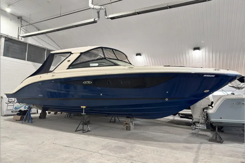  Yacht Photos Pics 2021 Sea Ray SLX 400 boat in indoor storage, blue hull, sleek design.