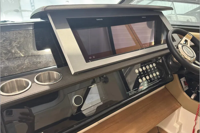  Yacht Photos Pics Dashboard of a 2021 Sea Ray SLX 400 boat with modern controls and steering wheel.