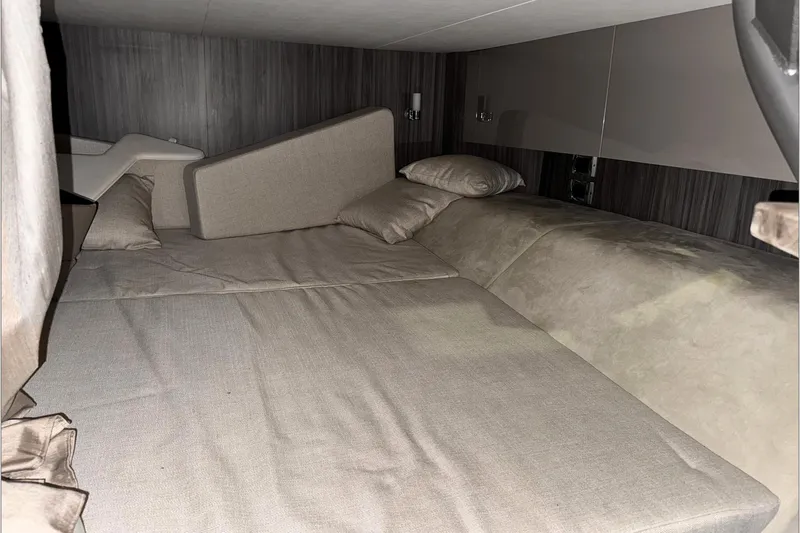  Yacht Photos Pics 2021 Sea Ray SLX 400 cabin interior with beige bedding and cushions.