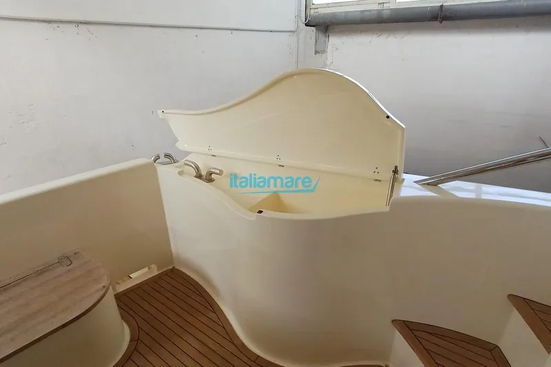  Yacht Photos Pics 2008 Ferretti Yachts 592 interior with wooden flooring and open storage compartment.