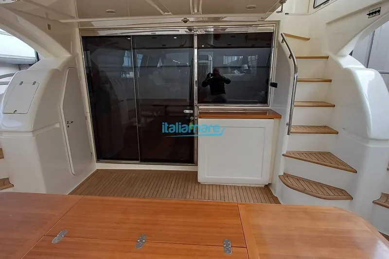  Yacht Photos Pics 2008 Ferretti Yachts 592 interior with wooden flooring and staircase.