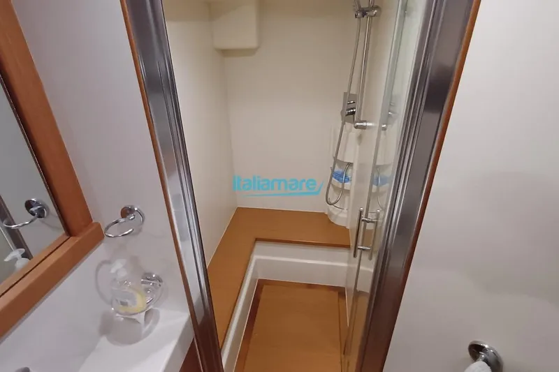  Yacht Photos Pics Bathroom interior of 2008 Ferretti Yachts 592 with shower and wooden accents.