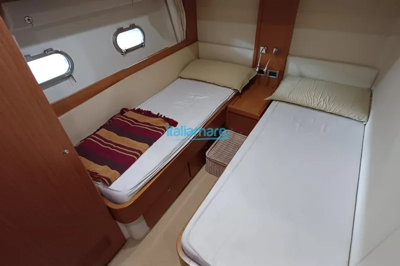  Yacht Photos Pics Twin cabin interior of 2008 Ferretti Yachts 592 with porthole windows.