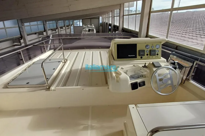  Yacht Photos Pics 2008 Ferretti Yachts 592 helm station with navigation controls and steering wheel.