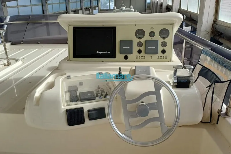  Yacht Photos Pics 2008 Ferretti Yachts 592 helm with Raymarine navigation system and steering wheel.