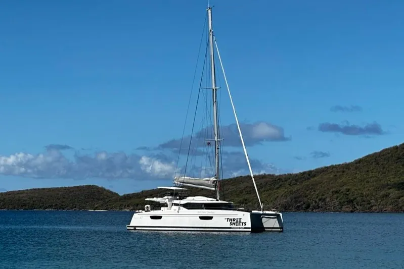 Three Sheets Yacht Photos Pics 2019 Fountaine Pajot Saona 47 catamaran anchored in serene blue waters.