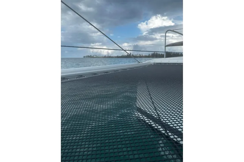 Three Sheets Yacht Photos Pics 2019 Fountaine Pajot Saona 47 catamaran deck with ocean and cloudy sky view.