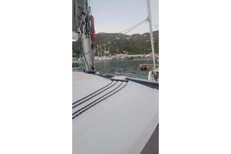 Three Sheets Yacht Photos Pics 2019 Fountaine Pajot Saona 47 catamaran docked in a scenic marina.