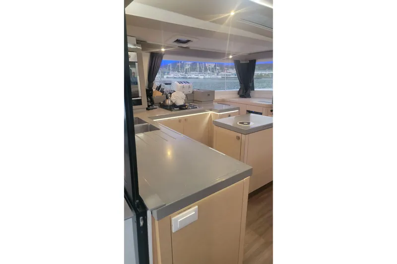 Three Sheets Yacht Photos Pics Modern kitchen interior of 2019 Fountaine Pajot Saona 47 catamaran with sleek countertops.