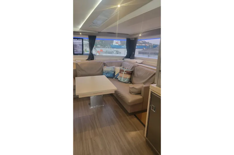 Three Sheets Yacht Photos Pics Interior of 2019 Fountaine Pajot Saona 47 yacht with cozy seating and table.