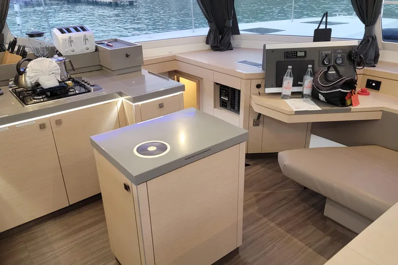 Three Sheets Yacht Photos Pics Modern kitchen interior of 2019 Fountaine Pajot Saona 47 catamaran with sleek design and appliances.