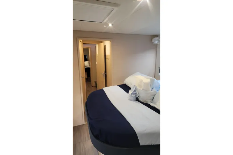 Three Sheets Yacht Photos Pics Interior cabin of 2019 Fountaine Pajot Saona 47 with cozy bed and modern decor.