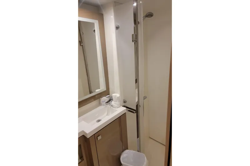 Three Sheets Yacht Photos Pics Bathroom interior of 2019 Fountaine Pajot Saona 47 yacht, featuring modern sink and shower.